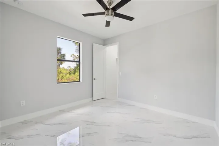 Spare room with ceiling fan