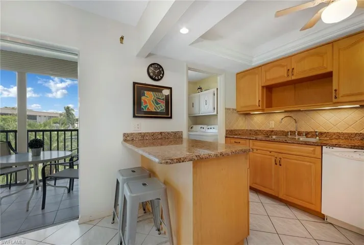 Kitchen w/ bar area and laundry room