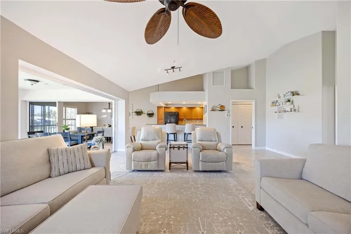 Living room with high vaulted ceiling and ceiling fan