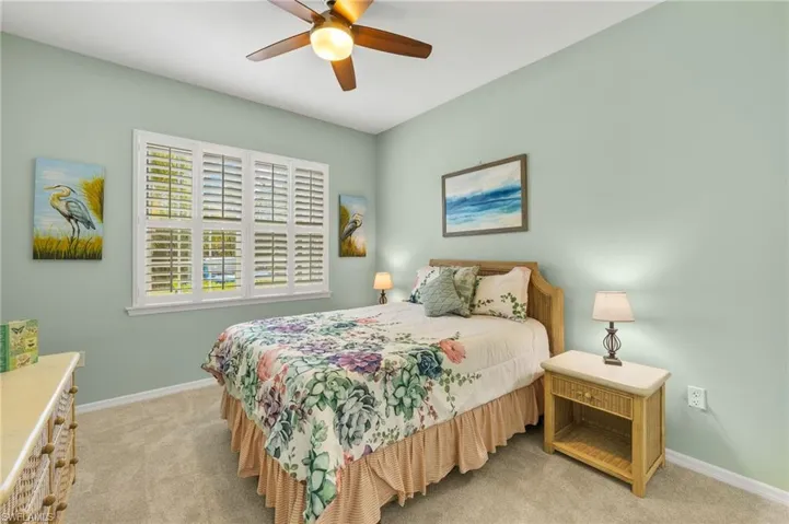 Bedroom featuring light colored carpet and ceiling fan