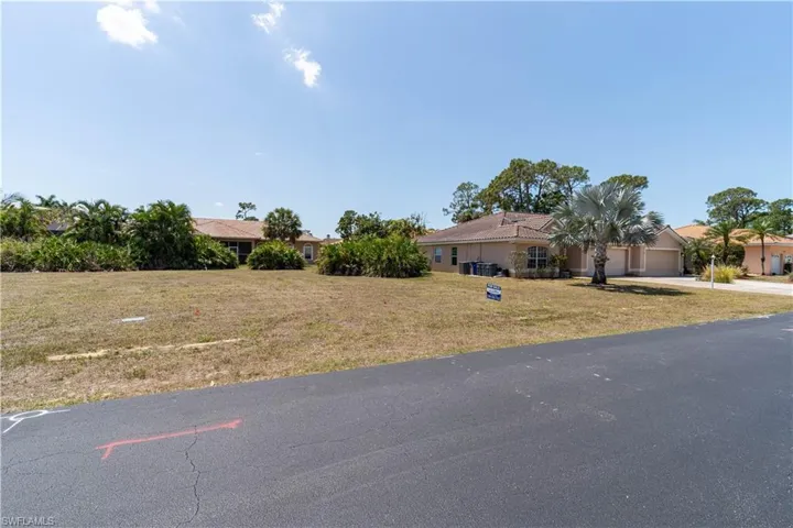 View of front of home featuring an attached garage, driveway, and a front yard