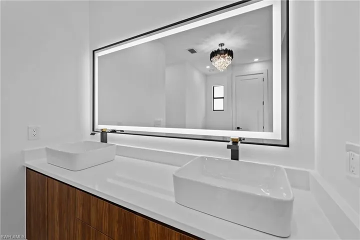 Bathroom with vanity and an inviting chandelier