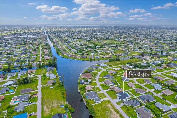 Birds eye view of property with a water view