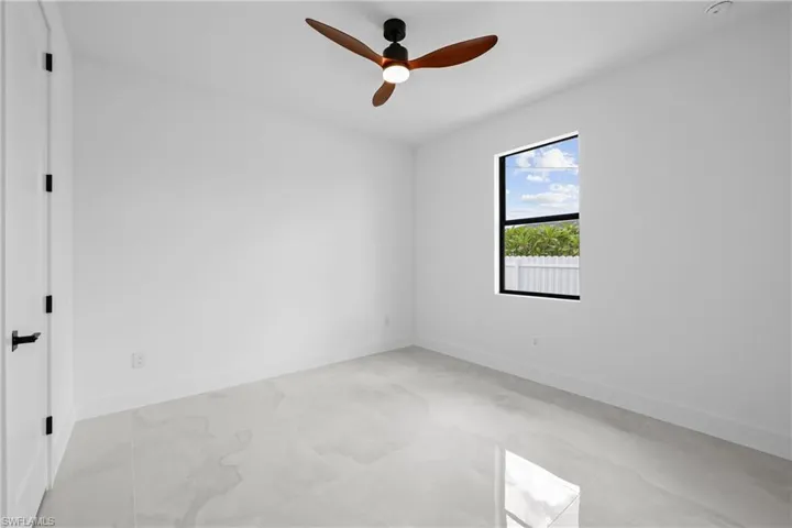 Empty room featuring ceiling fan