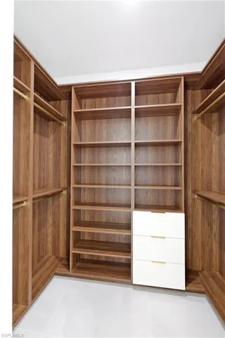 Spacious closet with light tile patterned flooring