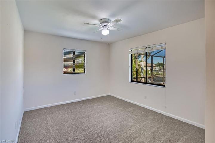 Rear Guest Bedroom overlooks the screened pool area.