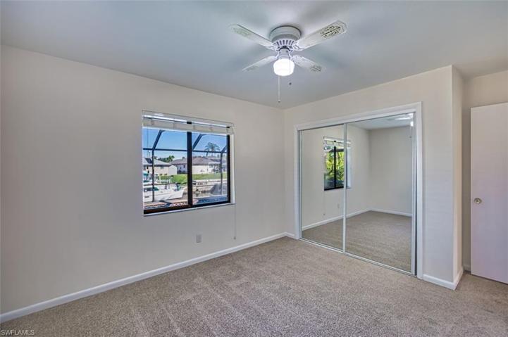 Rear Guest Bedroom has lighted ceiling fan and large closet.