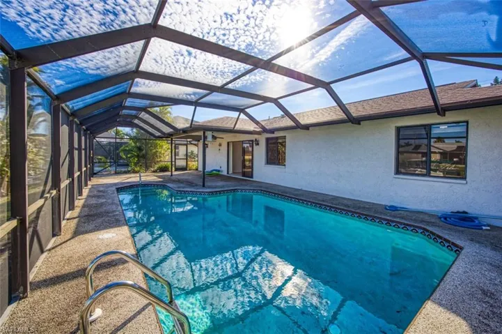 Large screened pool cage with solar heated pool.