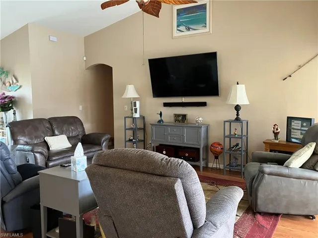 Living room featuring wood-type flooring and ceiling fan