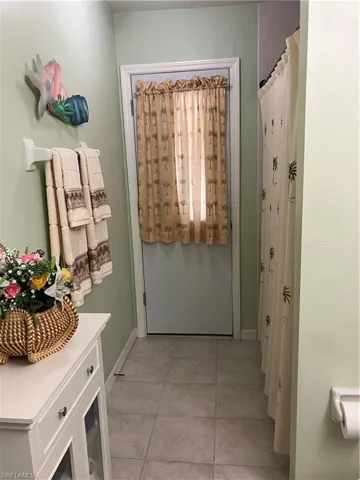 Doorway to outside featuring light tile patterned flooring