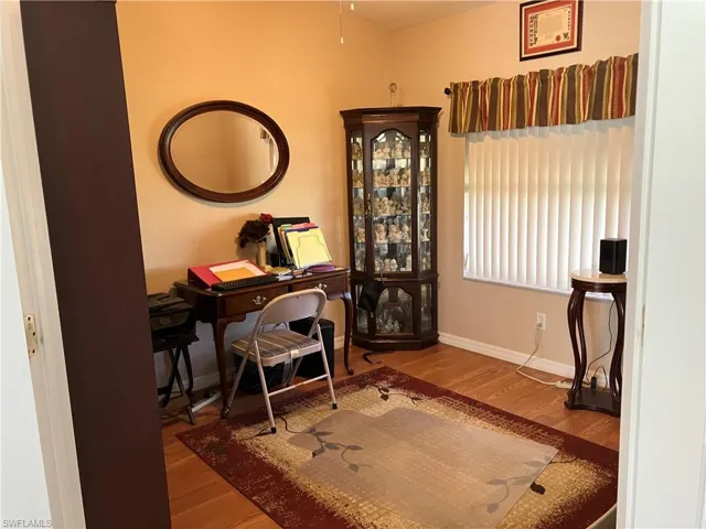 Office area with hardwood / wood-style flooring