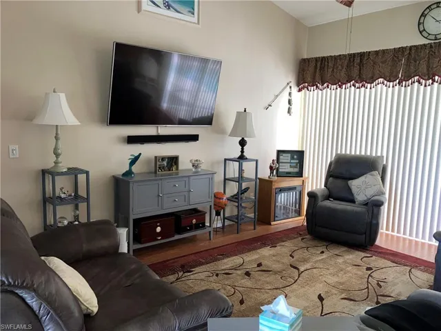 Living room with dark hardwood / wood-style floors