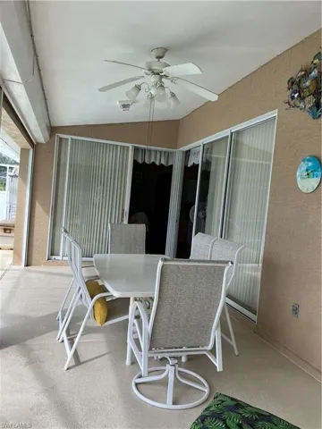 Sunroom / solarium featuring ceiling fan and lofted ceiling