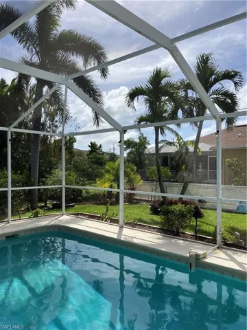 View of swimming pool and back yard