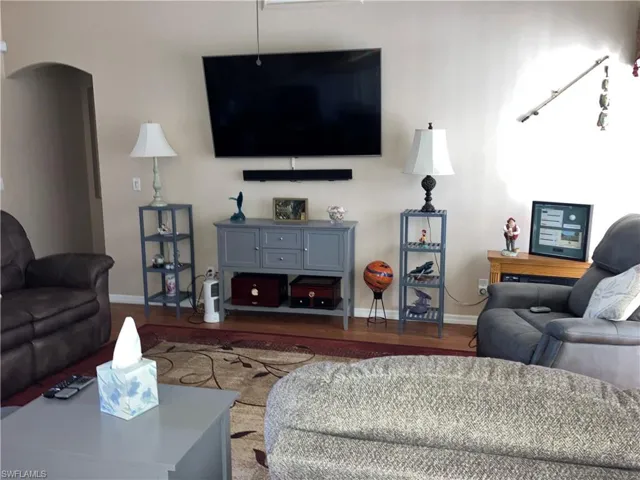 Living room with dark wood-type flooring