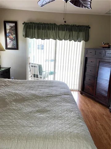 Bedroom featuring access to outside and light hardwood / wood-style flooring
