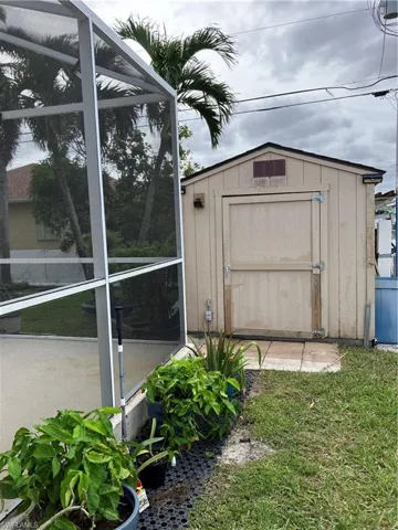 View of outdoor structure featuring a yard