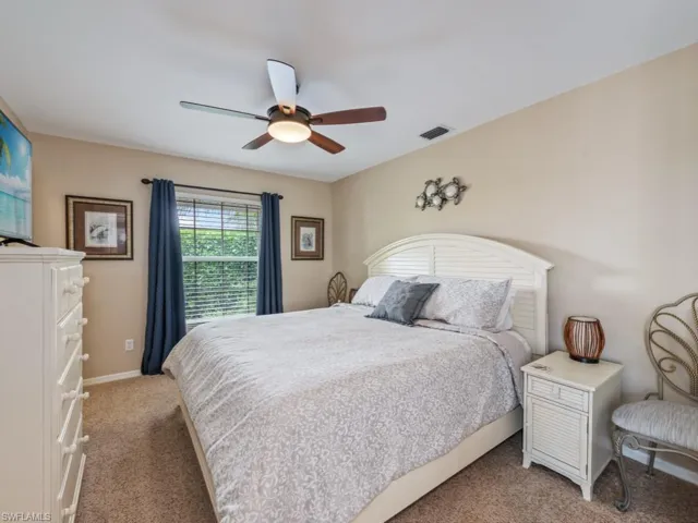 Bedroom featuring light colored carpet and ceiling fan