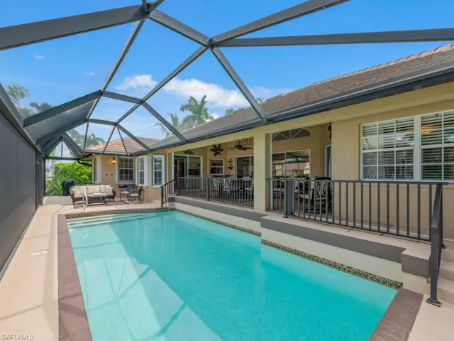 Outdoor pool featuring a patio, an outdoor hangout area, a ceiling fan, a sunroom, and glass enclosure