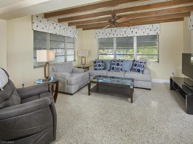 Living room features exposed wooden beams.