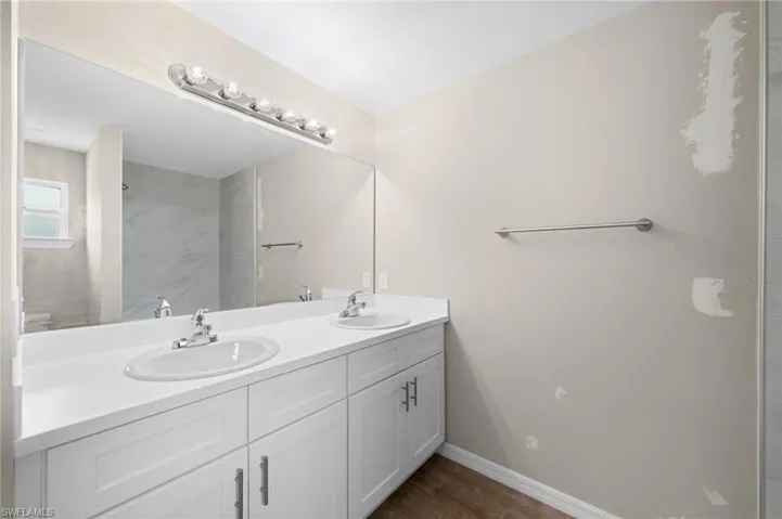 Bathroom featuring vanity and wood-type flooring