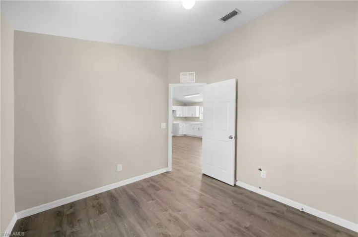 Empty room featuring wood-type flooring