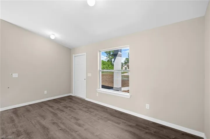 Unfurnished room with hardwood / wood-style flooring