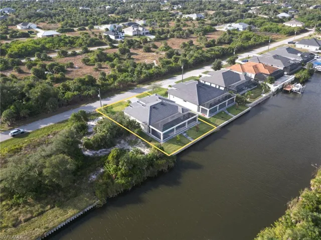 Aerial perspective of suburban area with a large body of water