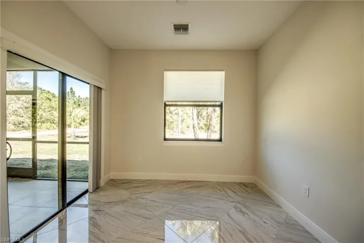 Unfurnished room with baseboards and light marble finish flooring