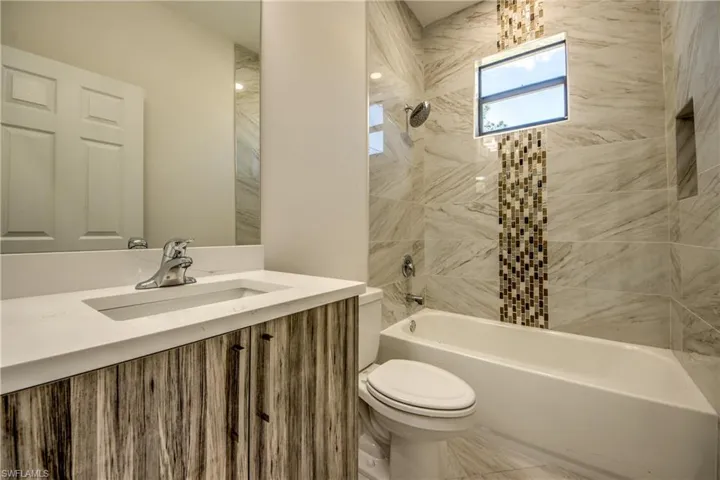 Bathroom with bathtub / shower combination and vanity