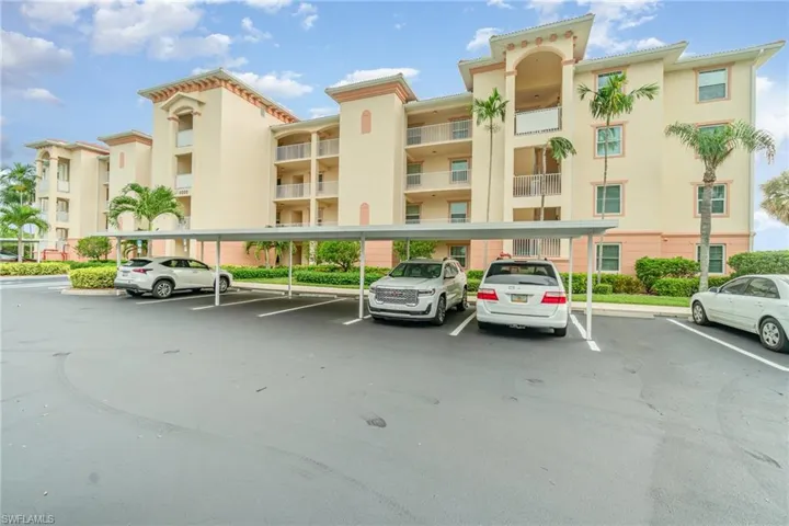 View of building / complex featuring covered parking