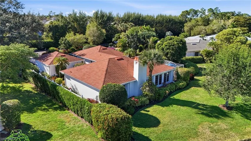 The detached garage and surrounding courtyard provide a setting unlike any other