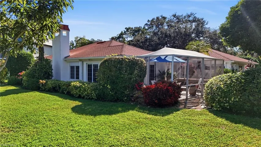 The back of the home features lake views off the screened lanai