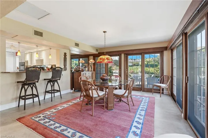 Dining Area features a bar area overlooking the kitchen and French sliding doors with incredible peaceful views
