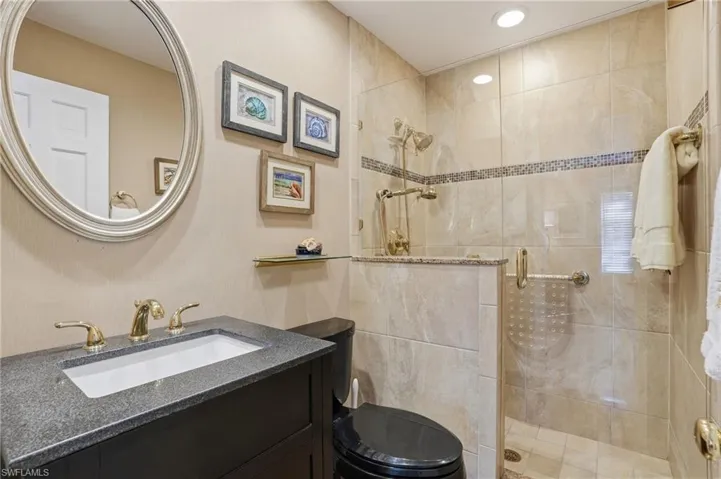 Full bath featuring an updated vanity and walk in shower