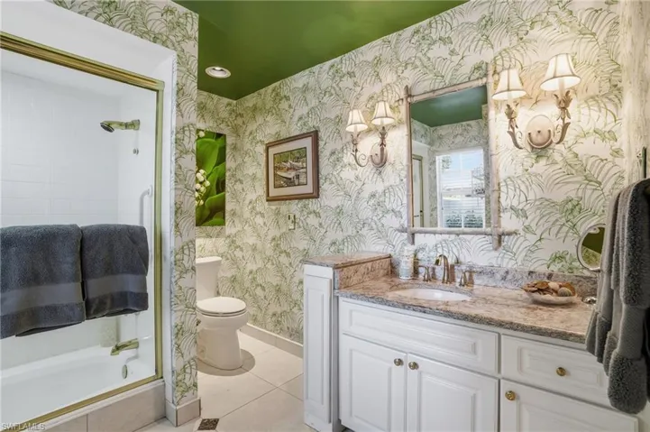 This second bedroom is also ensuite with a shower, updated vanity with granite counters