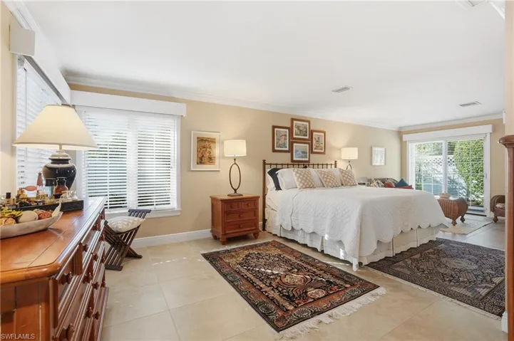 This spacious Primary Suite features a neutral palette and tile flooring