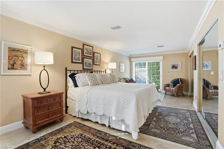 Bedroom featuring ornamental molding and a closet