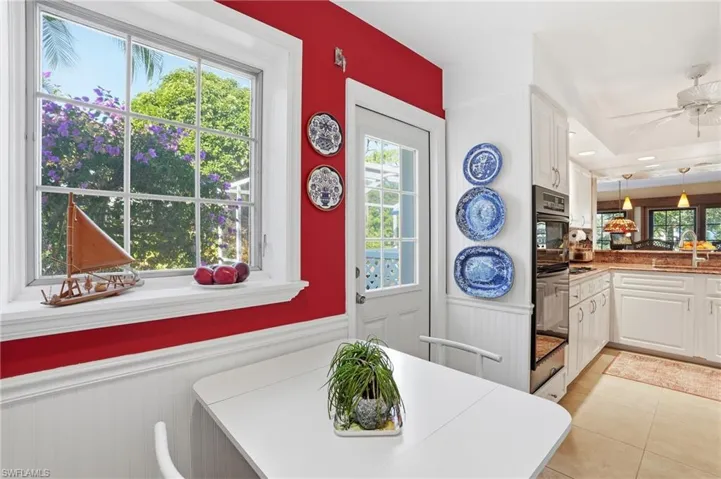Breakfast room featuring a wainscoted wall, recessed lighting, and light tile patterned flooring