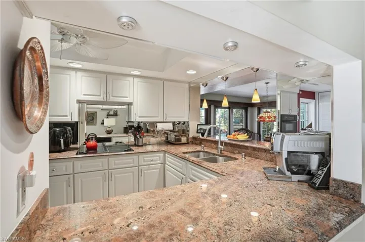 The updated kitchen has beautiful granite counters and plenty of storage space