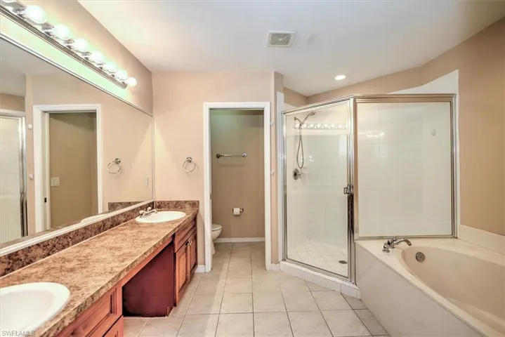Master bathroom with double sink and vanity area (room for chair)!