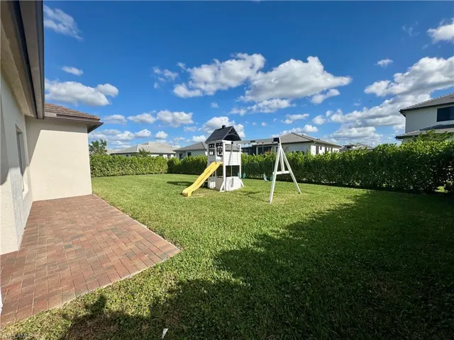 View of yard featuring a patio and a playground