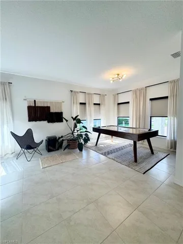 Playroom featuring visible vents, light tile patterned floors, and a textured ceiling
