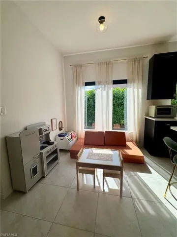 Living room with light tile patterned floors
