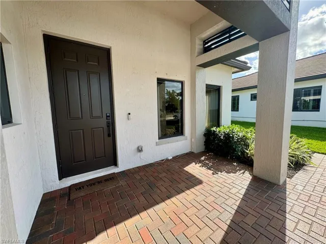 Entrance to property featuring stucco siding