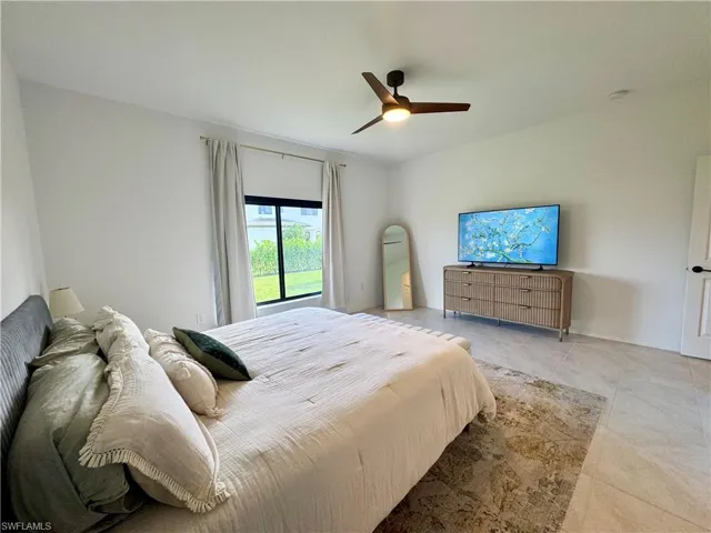 Bedroom featuring a ceiling fan and light tile patterned flooring
