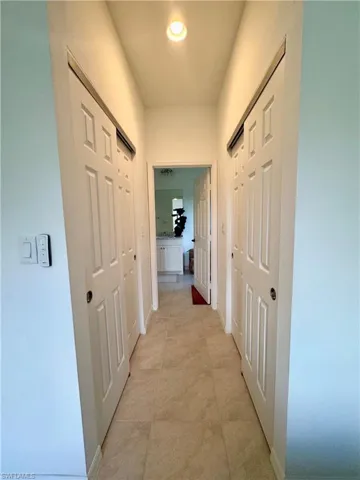 Corridor with baseboards and recessed lighting