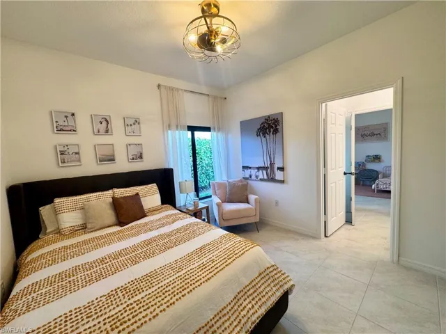 Bedroom with baseboards and light tile patterned flooring
