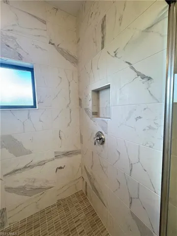 Bathroom featuring a tile shower