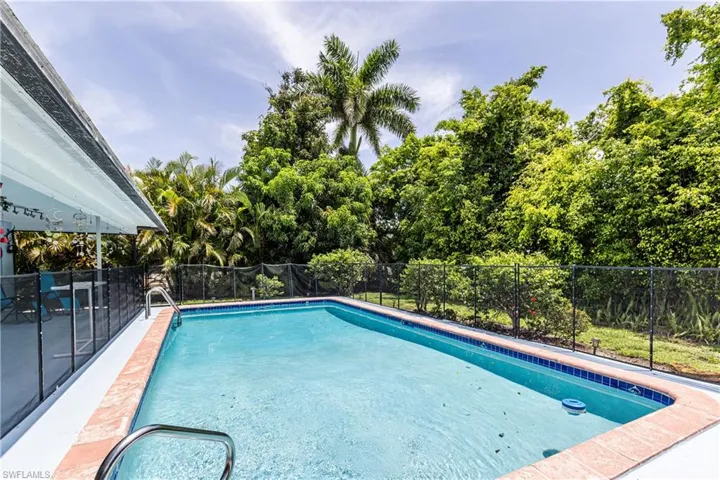 View of swimming pool featuring view of scattered trees